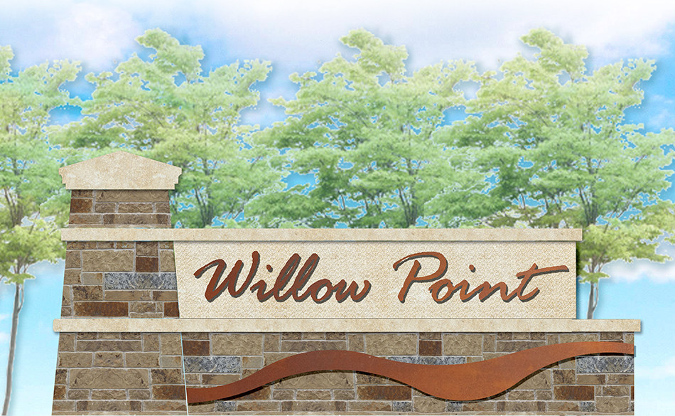 Close up of a sign that says Willow Point in brown against a tan stone background and green trees behind